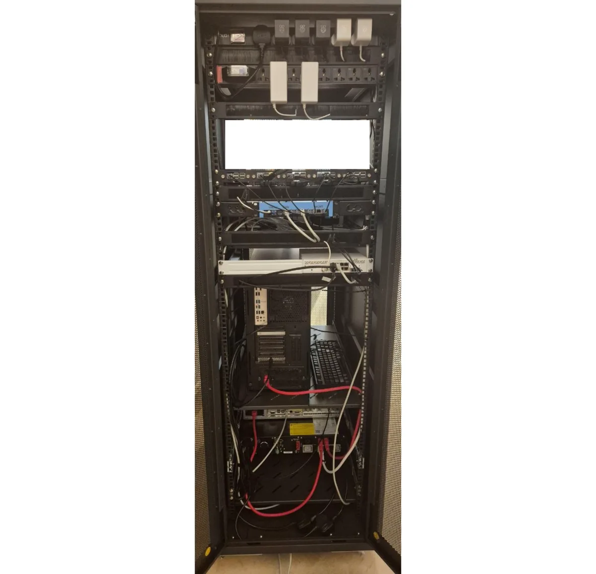 Back view of my homelab rack showing networking, cabling, servers, and power